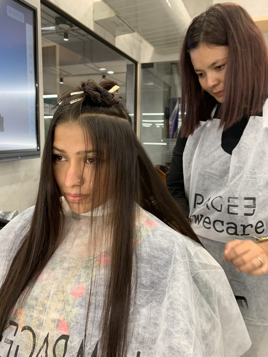 Precision haircut in progress at Page 3 Salon